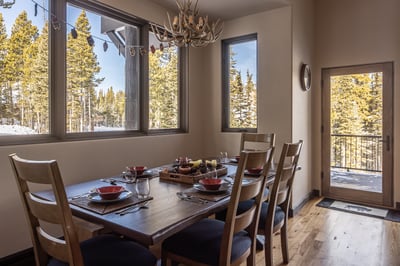 Gather around your elegant dining table for memorable meals while enjoying stunning forest views thr