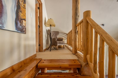 Cozy wooden stairway leads to your peaceful reading nook, where natural light and rustic charm creat