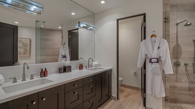 Primary ensuite with double sinks, shower, and large tub
