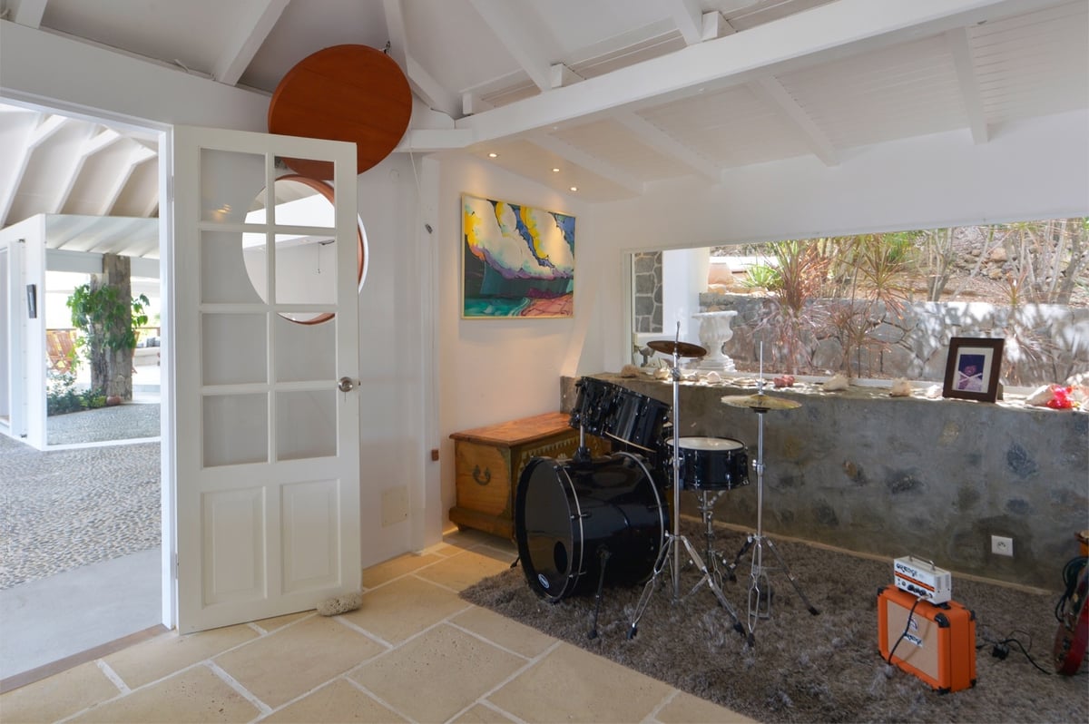 Music Room: Small corner equipped with instruments such as a drum kit and a guitar. - Image 19