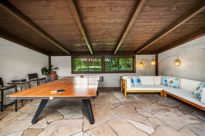Challenge a friend to table tennis under the rustic wood-beamed ceiling, then relax on the cozy sect