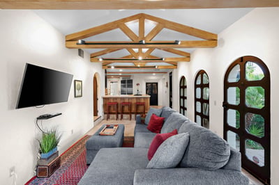 Stretch out on plush seating beneath stunning vaulted wood beams. Your private retreat flows into a 