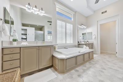 Primary bathroom. Dual sinks and an additional vanity, stand alone shower, and jetted tub.