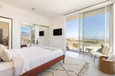 Guest bedroom 3 with king bed, en suite bath and direct access to balcony overlooking the pool