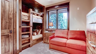 Bunkroom on lower level with full over full bunk and full sleeper sofa, sleeps 2-4