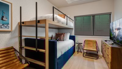 Twin-over-twin bunk bed with an additional twin trundle, on the upper level sharing a jack-and-jill 