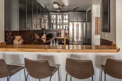 Your modern kitchen invites culinary adventures with sleek cabinetry, gleaming countertops, and prof