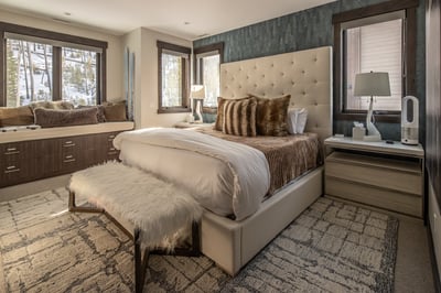 Sink into luxury with your plush king bed overlooking snowy mountain views, complete with cozy faux 