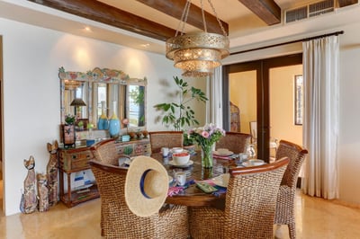 Comfortable seat 6 in the rustic straw-woven chairs of Hacienda Tranquila's dining area.