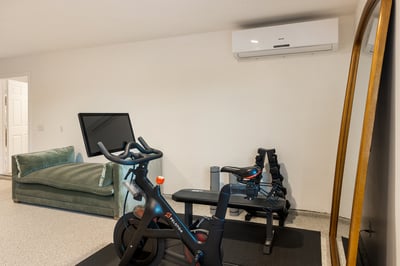 Keep up your routine with your own Peloton and weight bench.