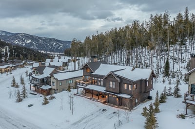 Stunning mountain lodge nestled in snowy alpine landscape with scenic winter views and neighboring c