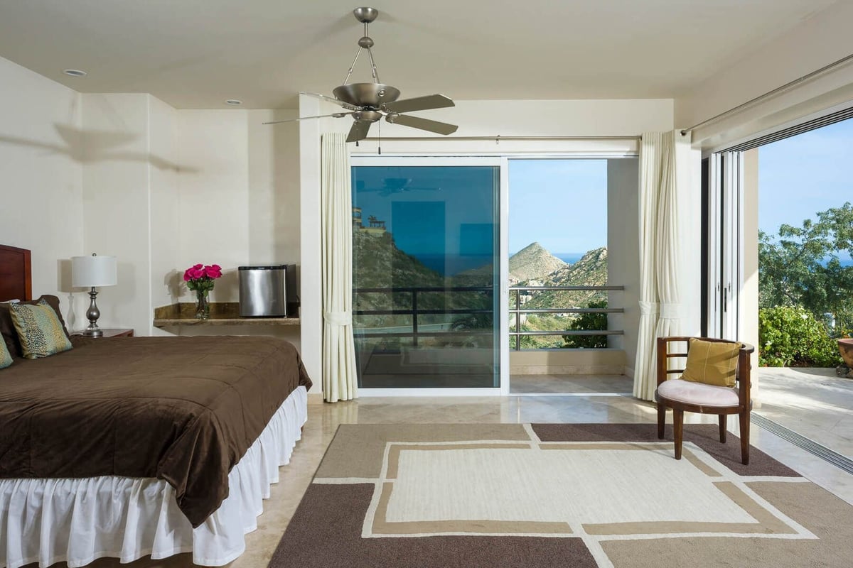Wide sliding glass doors and windows bring in plenty of warm Cabo sun to brighten and open up the ro - Image 21