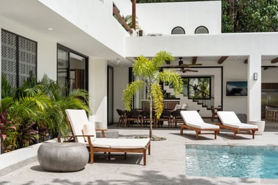 - Wood framed loungers placed just steps from the refreshing pool & garden edge
- Small palm adds is
