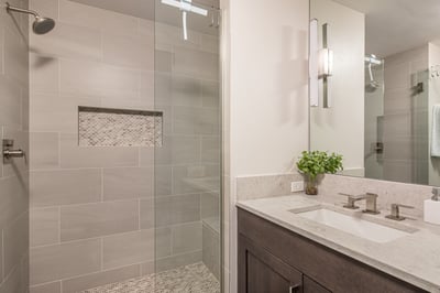Unwind in your luxurious en-suite with a spacious walk-in shower, elegant marble vanity, and modern 