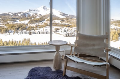 Sink into this stylish chair and savor breathtaking mountain views through floor-to-ceiling windows—