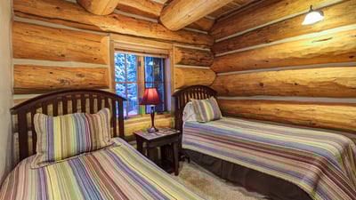 Bedroom with two twin beds, shared bathroom with queen bedroom