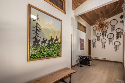 Step into your artistic retreat where mountain-themed artwork and handcrafted dreamcatchers create a