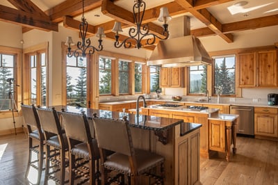 Gather around the grand island in this warm, light-filled kitchen with elegant wood beams.