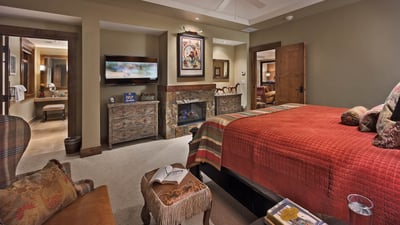 Primary suite with fireplace and TV
