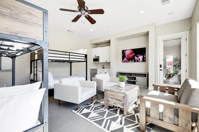 Casita living room space- Features 2 queen bunk beds, sitting area, Smart TV, and kitchenette.