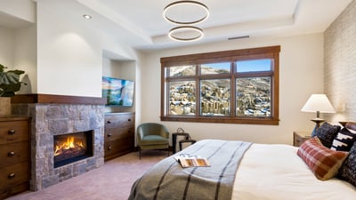 Primary suite with fireplace and TV