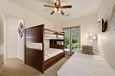 Guest bedroom 4 with bunk bed (full on top and bottom) plus additional twin bed.