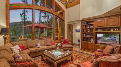 Main level great room with TV, views and deck access