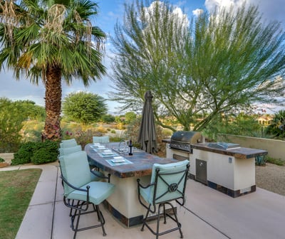 Outdoor kitchen with sink, BBQ and seating for 6.