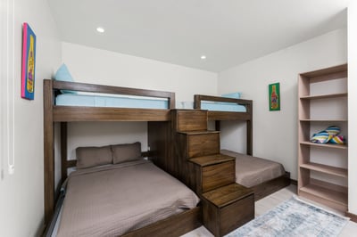- Perfect for groups or families, this stylish room sleeps four with ease
- Modern stacked bunks wit