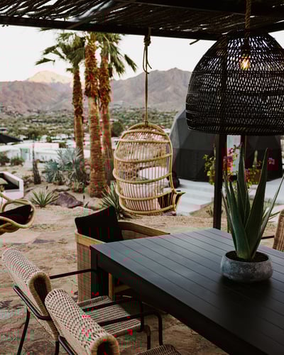Chic hanging chairs around the outdoor dining area