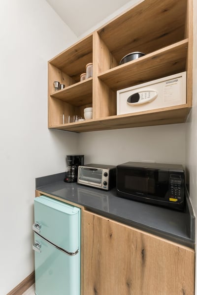 - Whip up snacks and morning coffee in this compact kitchenette with all essentials
- Includes a ret