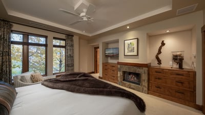 Primary suite with fireplace and TV