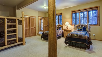 Lower level bedroom with bunk bed and two twin beds
