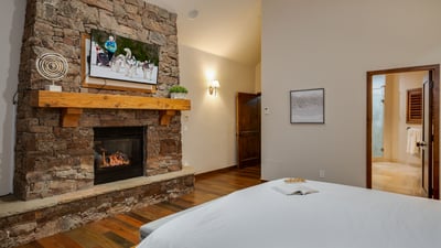 Primary suite on upper main level with fireplace