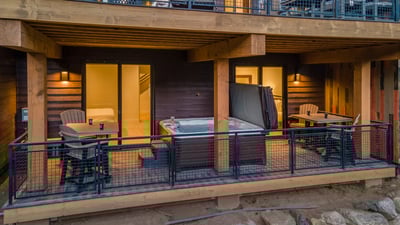 View of the lower deck and hot tub, with direct access to both lower level bedrooms