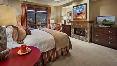Primary suite with fireplace and TV