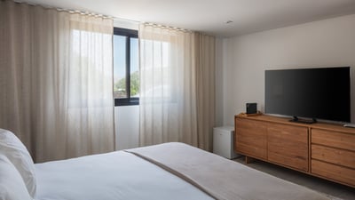 Bedroom 3: On the upper level of a separate building. Euro king size bed, air conditioning, HD-TV. E