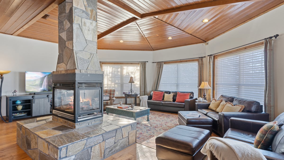 Great room with 4-sided fireplace and seating - Image 1