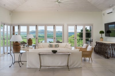 - Lounge in soft white seating surrounded by tall glass doors and natural light
- Soak in breathtaki