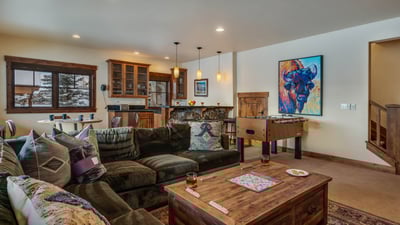 Lower level family room with foosball, game table, and wet bar
