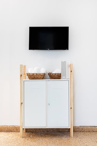 Home gym with yoga mats, yoga blocks, row machine, TV and more!