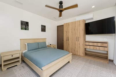 - Enjoy restful nights in this serene bedroom featuring teal bedding and light wood tones
- Watch yo