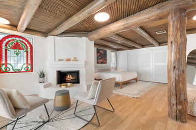 Primary suite in main house with king bed, walk-in closet and en suite bathroom