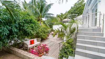 Outdoors: Two-level property, surrounding by a lush tropical garden. Private parking at the entrance