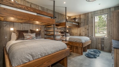 Bunk room 1 on lower level with two sets of twin over queen bunks, ensuite bath