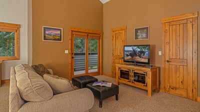 Bedroom 1, Upper Level - Primary king suite with TV, balcony, and queen sleeper sofa