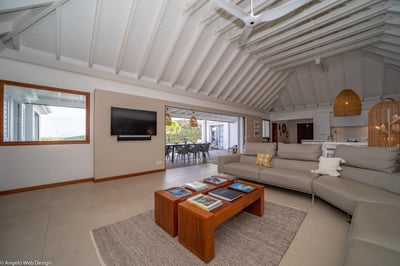 Living Area: Ocean view and green hills. Living room open to the kitchen and dining room is welcomin
