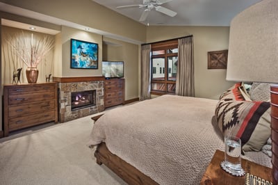 Primary suite with fireplace and TV