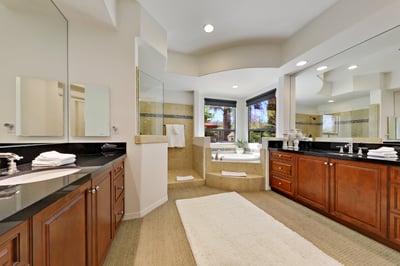 Primary en suite bathroom with shower and soaking tub.