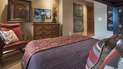 Bunkroom with a twin over queen bunk and TV